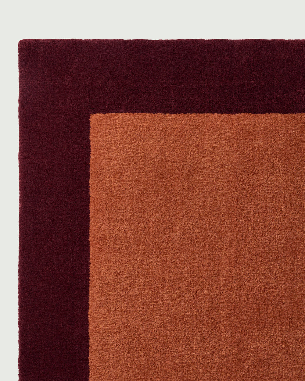 Minimalist Terracotta and Maroon Border Rug